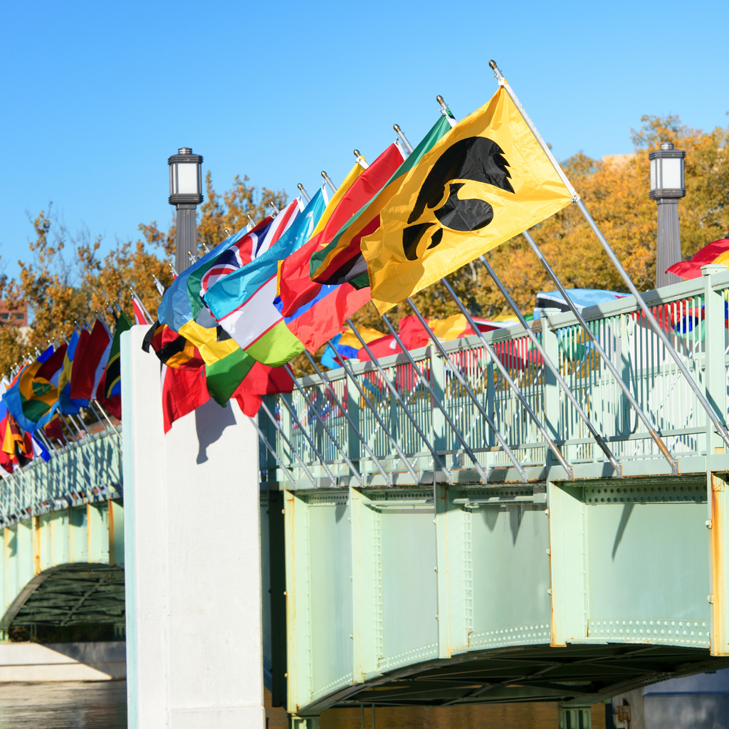 Flags of many countries displayed on the pedestrian bridge over the Iowa River.