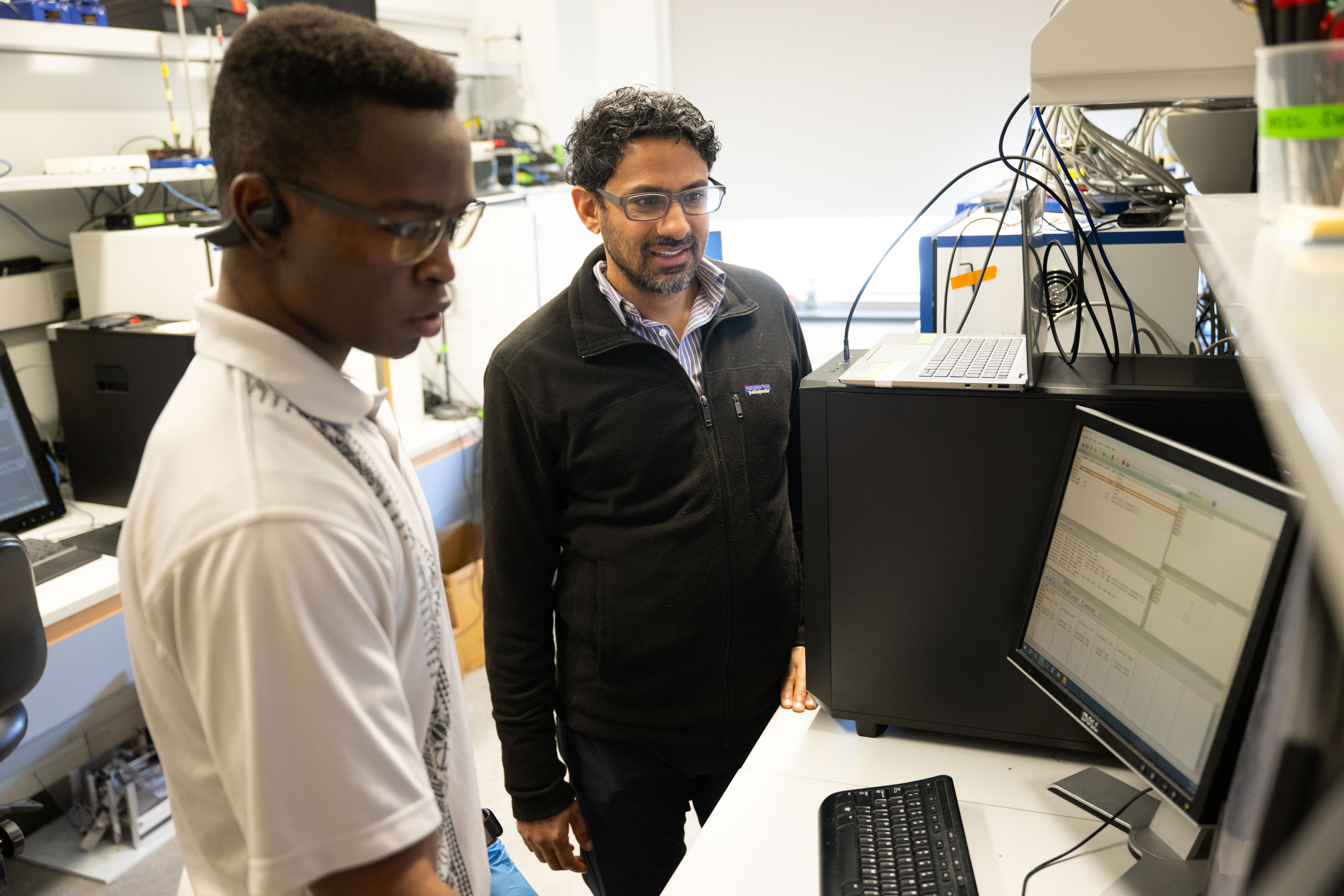 faculty and student discussing results on computer
