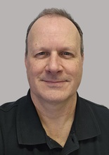 A headshot of Ed Gillan