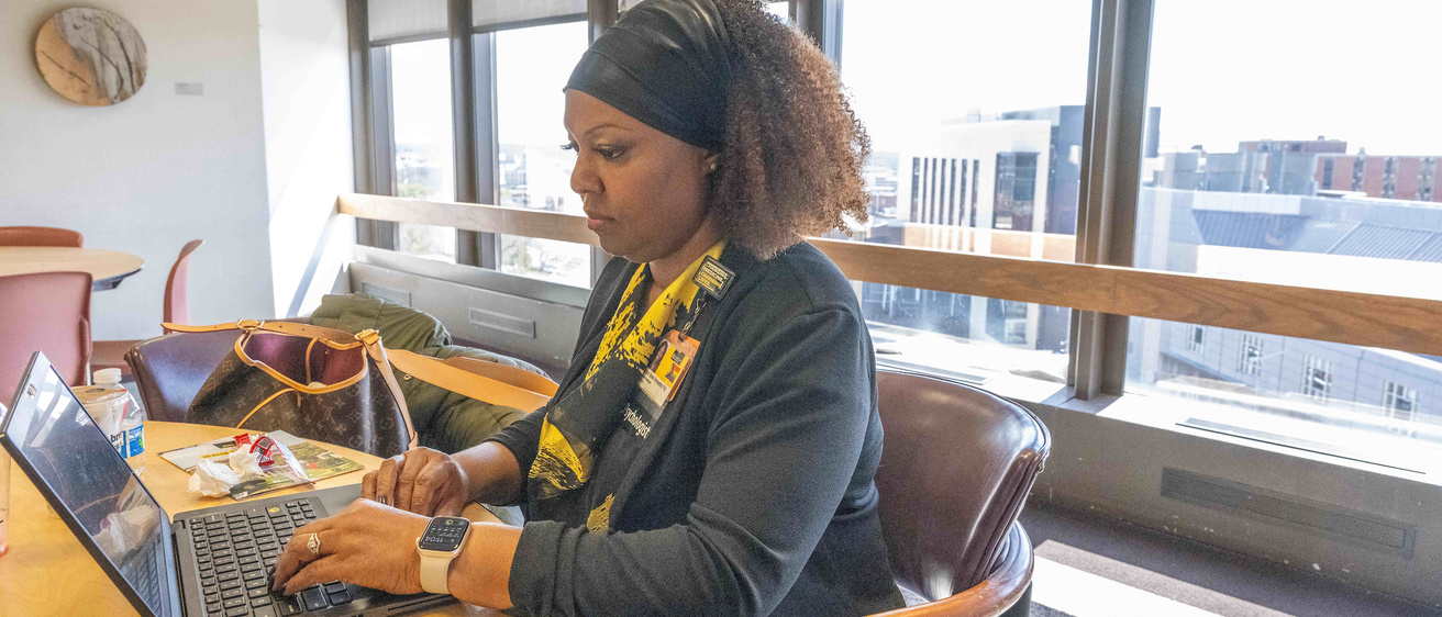 Faculty member on a laptop