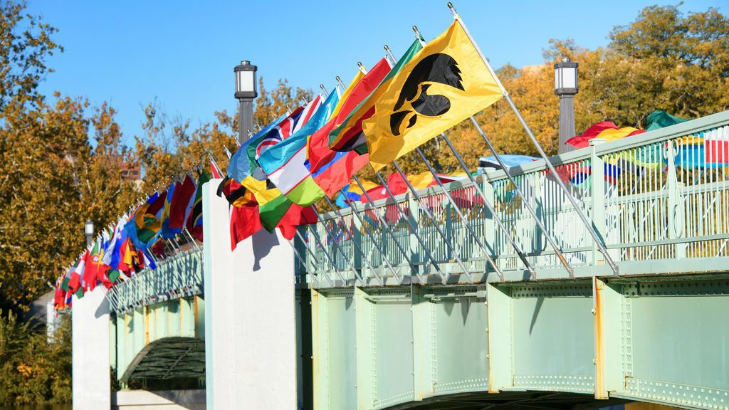 Flags of many countries displayed on the pedestrian bridge over the Iowa River.