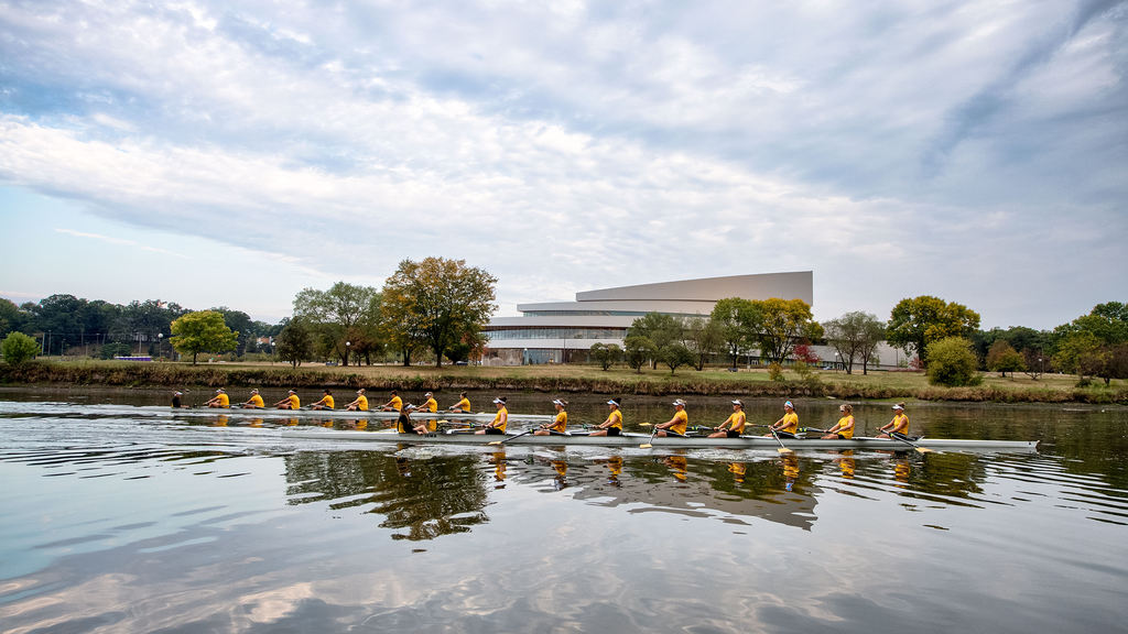 Rowing on Iowa River in front of Hancher Auditorium